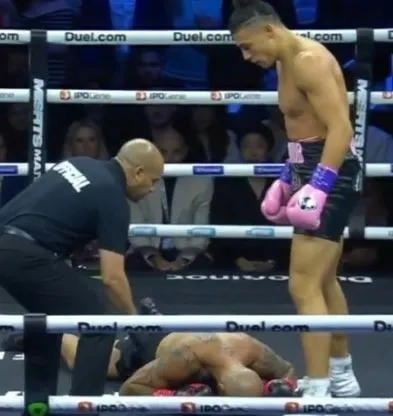 Andrew Tate Standing Over a Fallen Opponent meme template