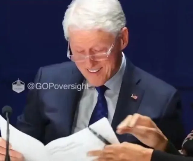 Bill Clinton Laughing While Reading Papers meme template