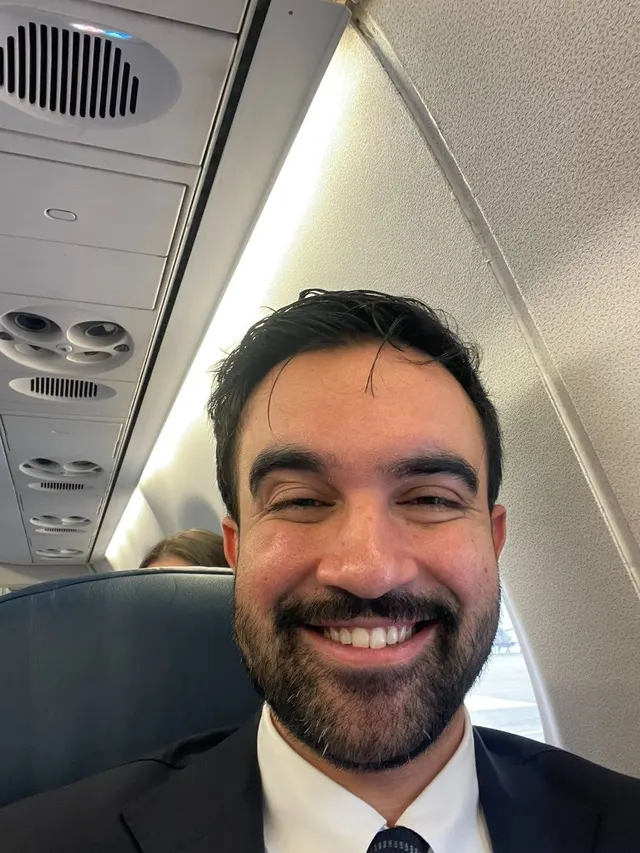 Zohran Mamdani Smug Selfie on an airplane meme template